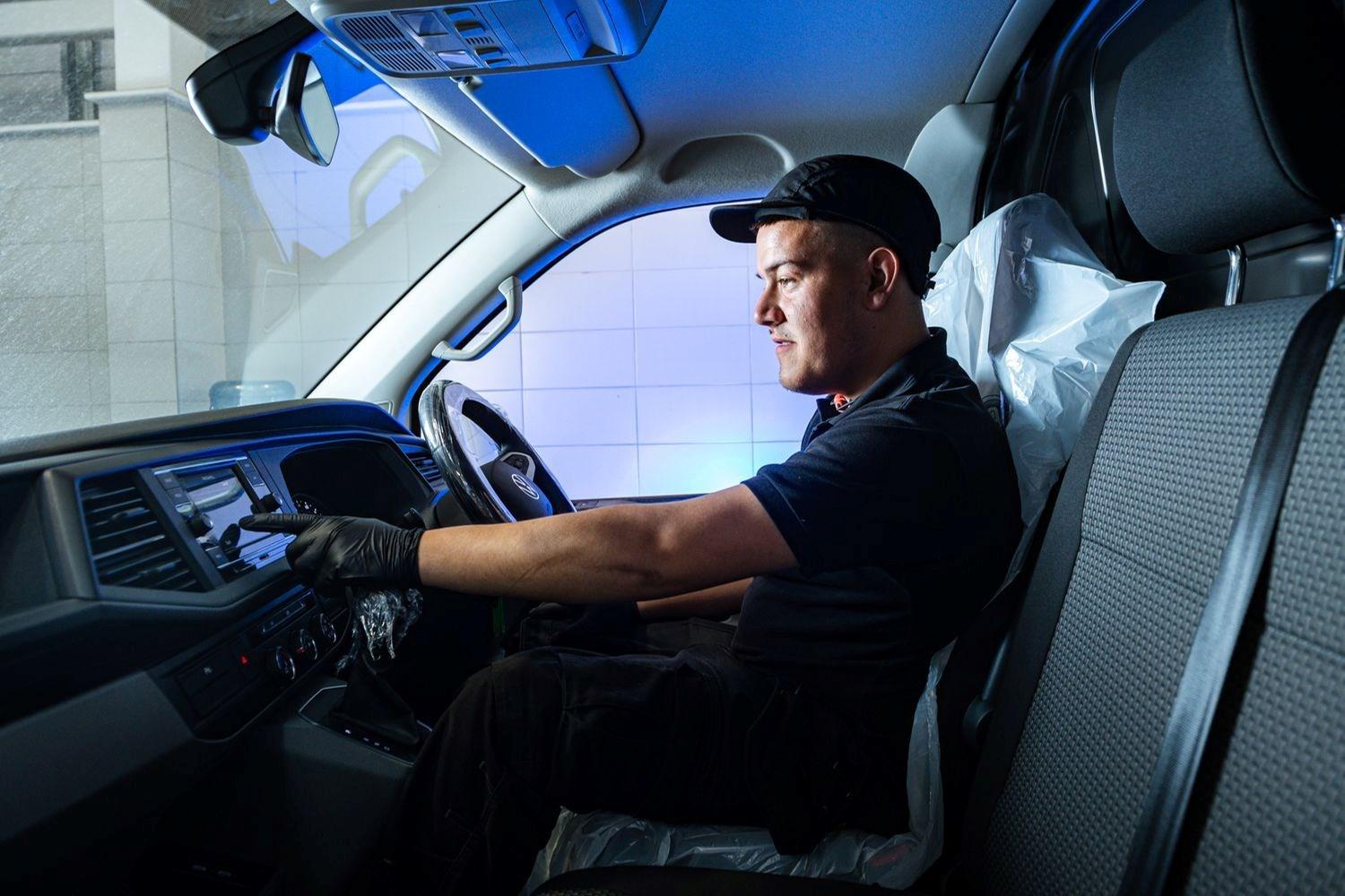 Volkswagen Technician inspects dashboard for electrical faults during Volkswagen Commercials Health Check at Volkswagen Approved Repair Centre at Agnew Van Centre, Mallusk
