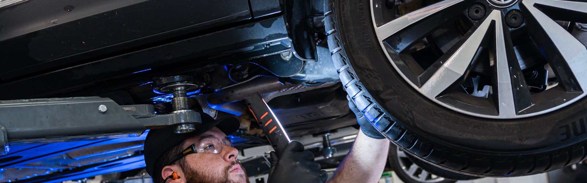 Volkswagen Service Specialist inspects Volkswagen ID.4 tyre tread with light during Volkswagen Healthcheck at the Volkswagen Approved Accident Repair Centre, Agnew Volkswagen Mallusk