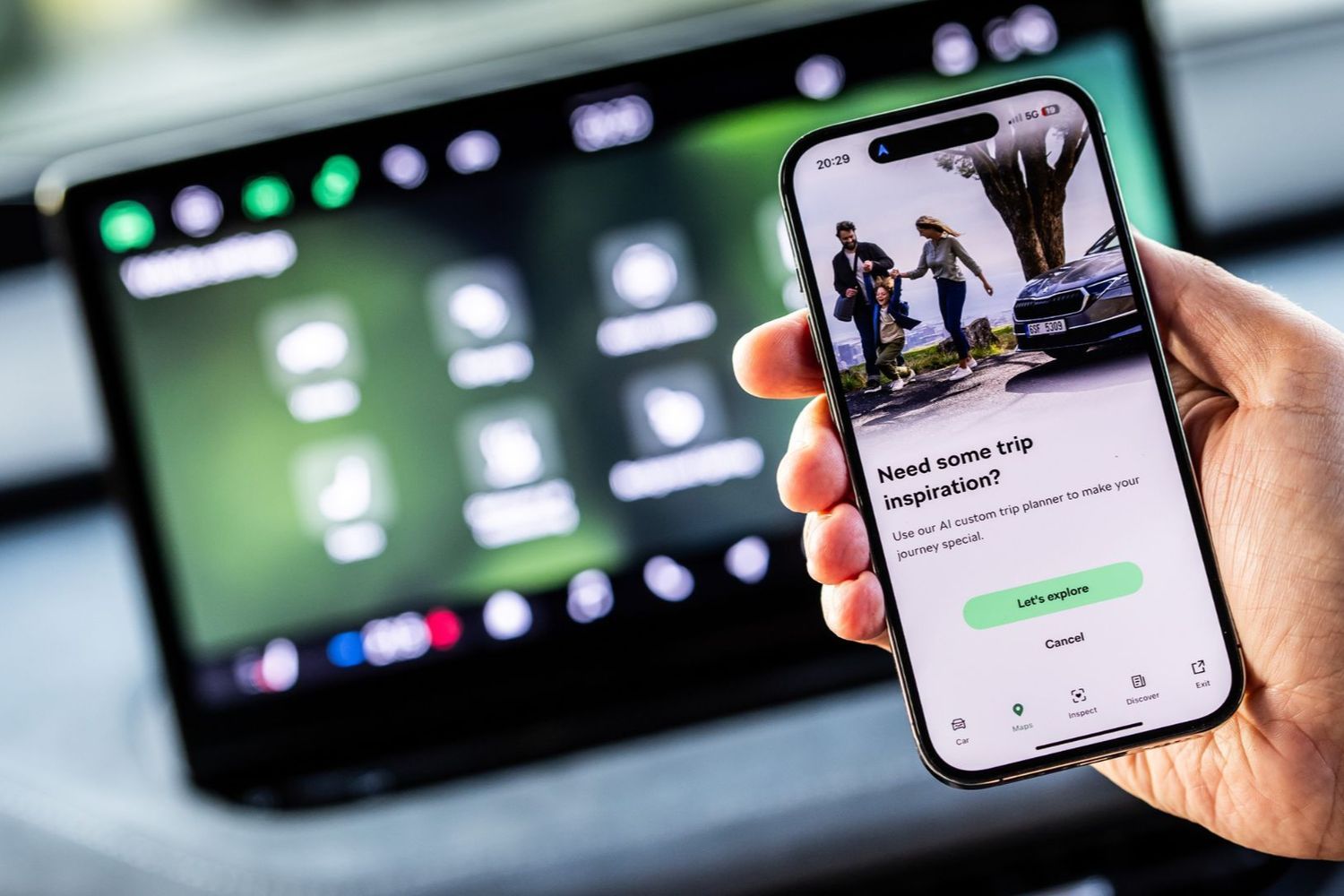 Experience Skoda Connect. Stay Connected. Drive Smarter. User holds up mobile phone with Skoda Connect open.
