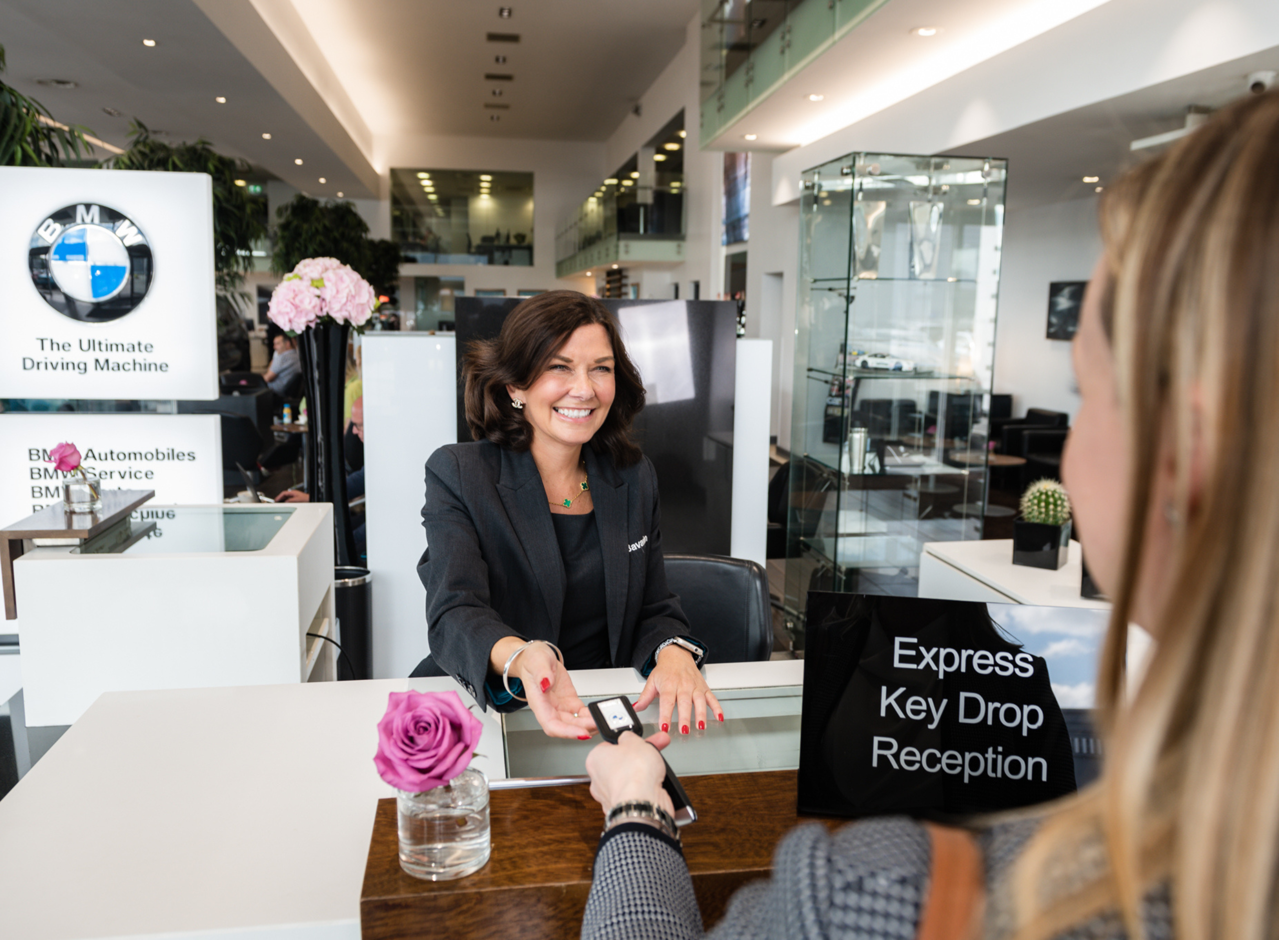 Customer handing keys to staff