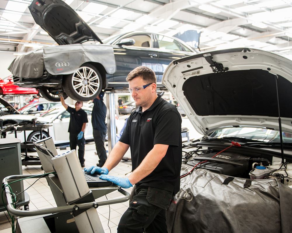Audi Technician insprects battery during battery recharge
