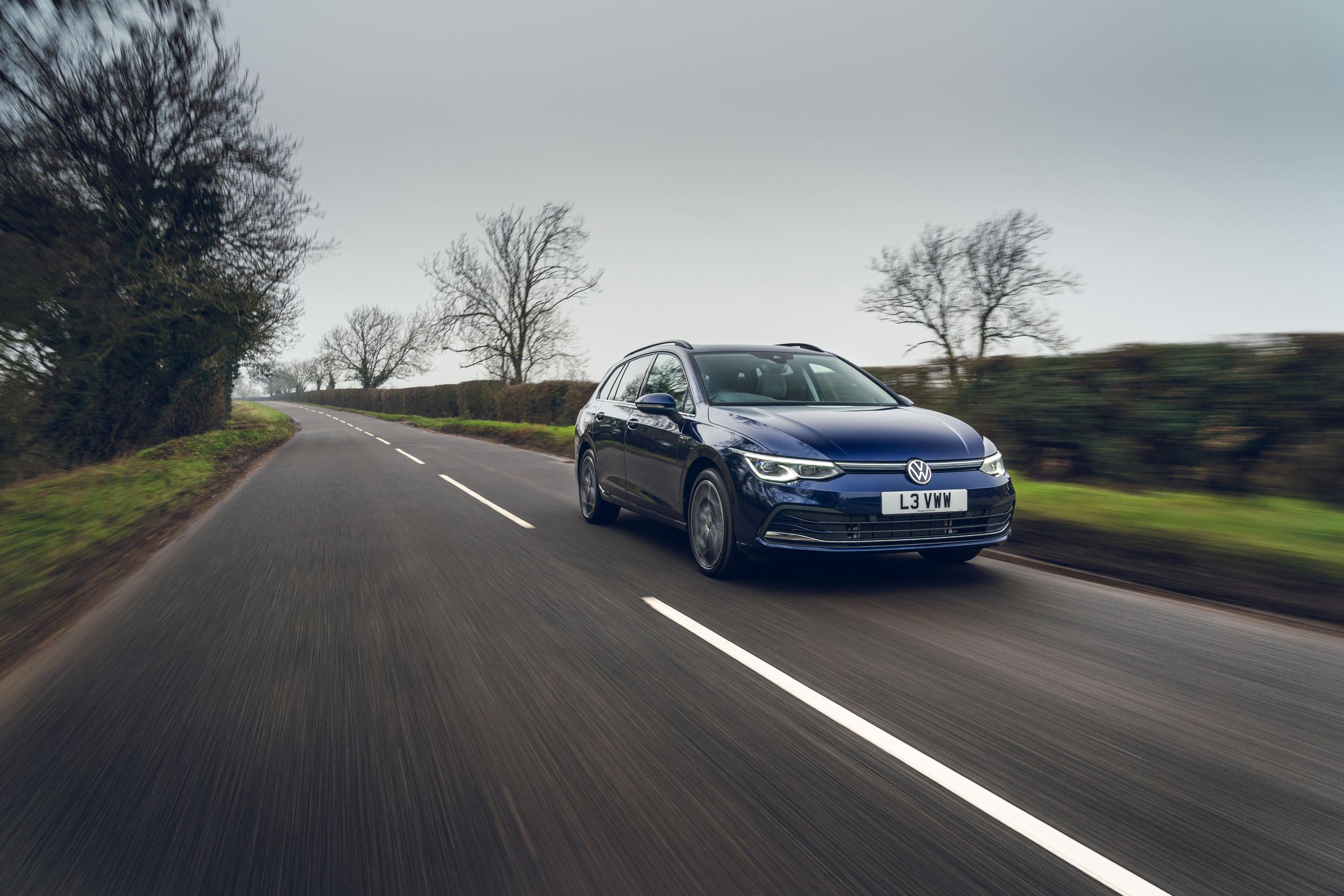 Front view of the new Volkswagen Golf Estate in blue, driving along country road