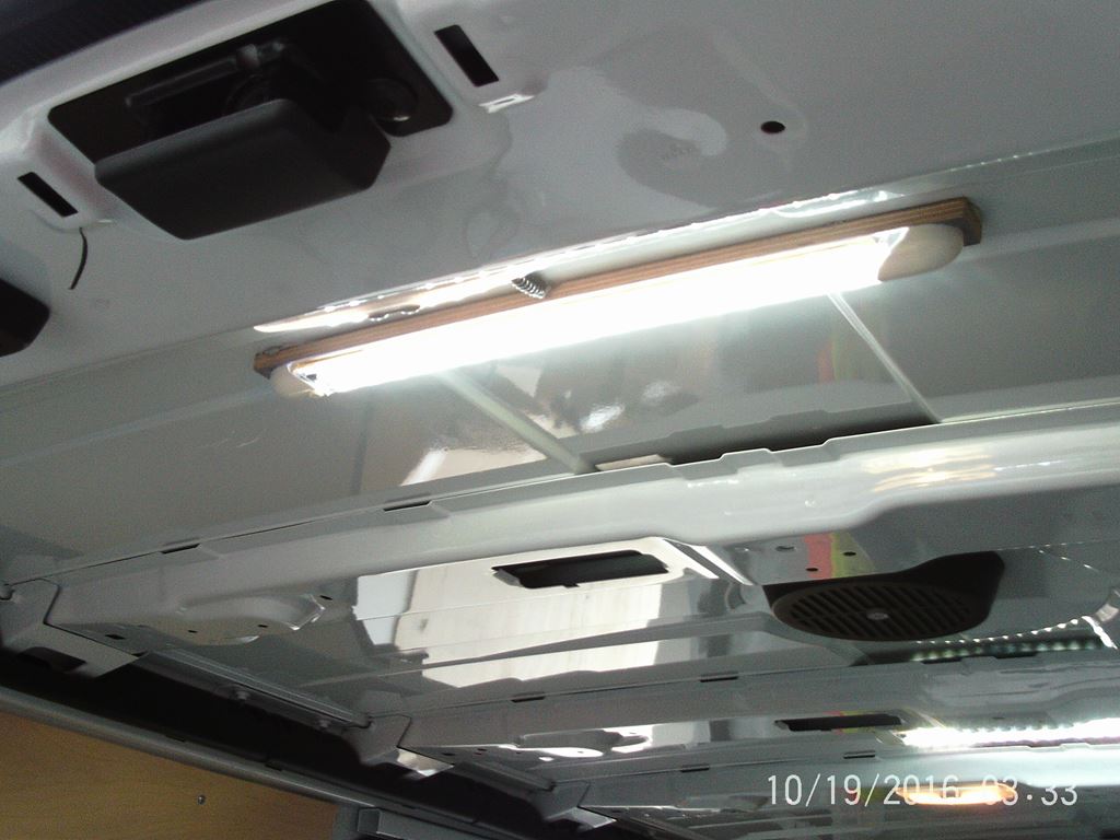 Interior roof of a van showing a fitted LED strip light for workspace illumination.