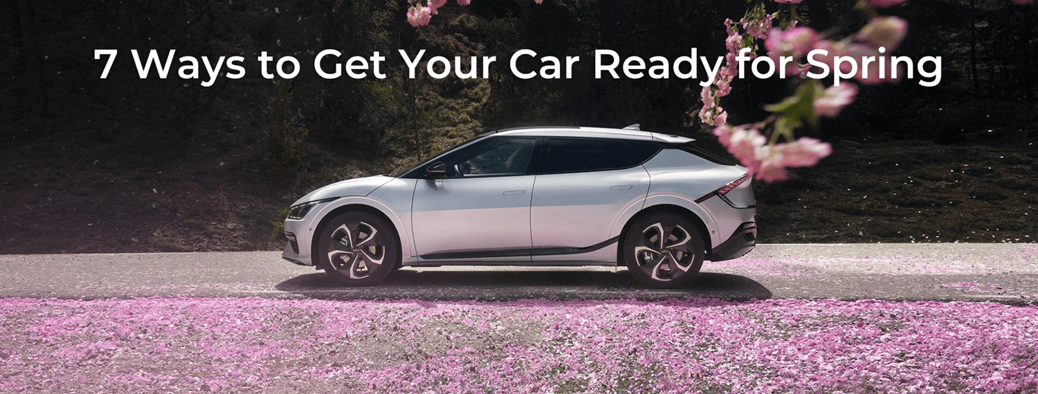 Kia EV6 driving along a road covered in pink cherry blossoms. Overlay text reads: 7 ways to get your car ready for spring