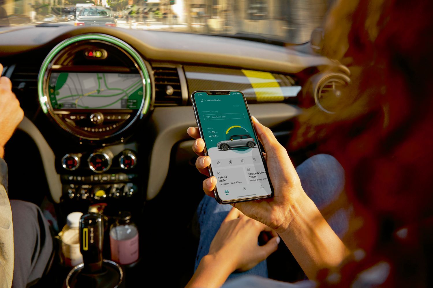 Passenger in MINI Cooper uses the MINI Connected App to get the most out of their MINI