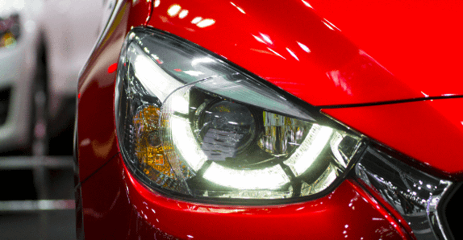 Close up of front LED lights on a red car