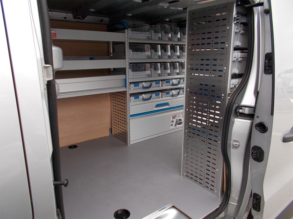 Van interior with racking, storage bins and perforated panel for tools near the side door