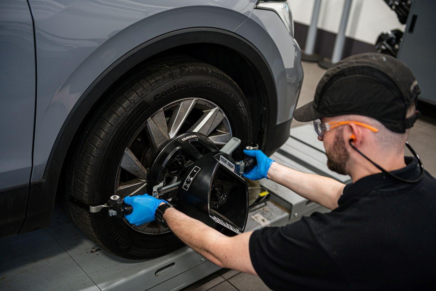 Volkswagen Service Specialist inspects Volkswagen ID.3 tyre for maintenance during service at the Volkswagen Approved Accident Repair Centre, Agnew Volkswagen Belfast