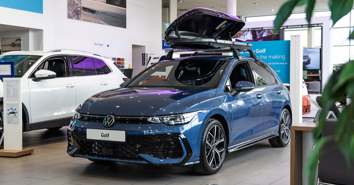 Volkswagen Golf parked in dealership showroom