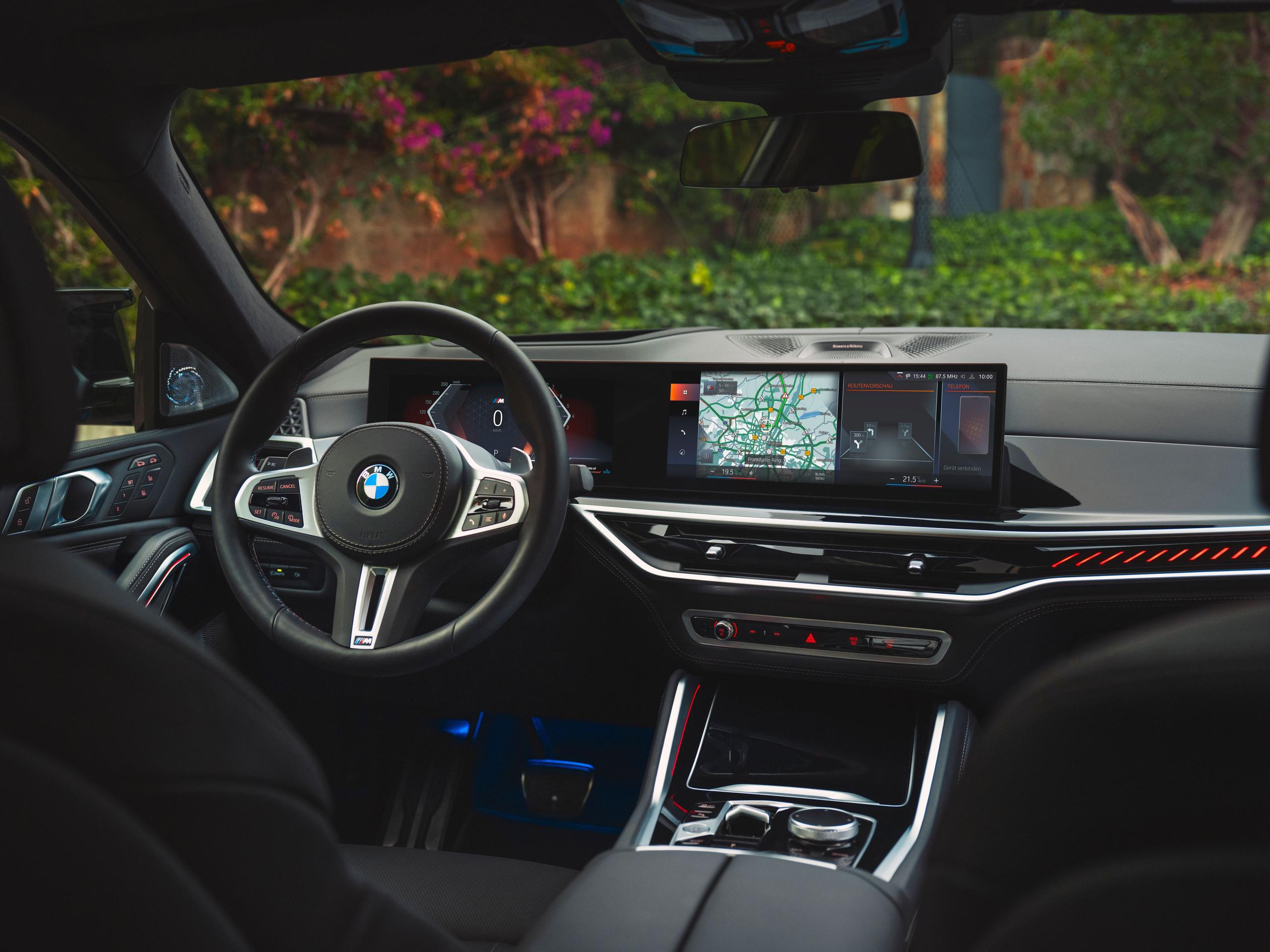 Interior view of new BMW X6, close-up of the steering wheel and infotainment system