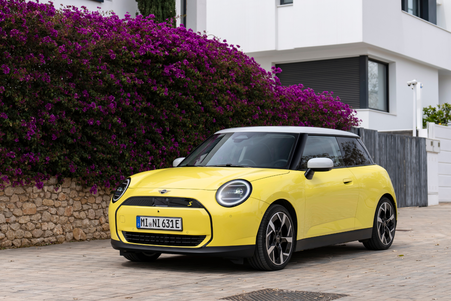 A yellow All-Electric Mini Cooper.
