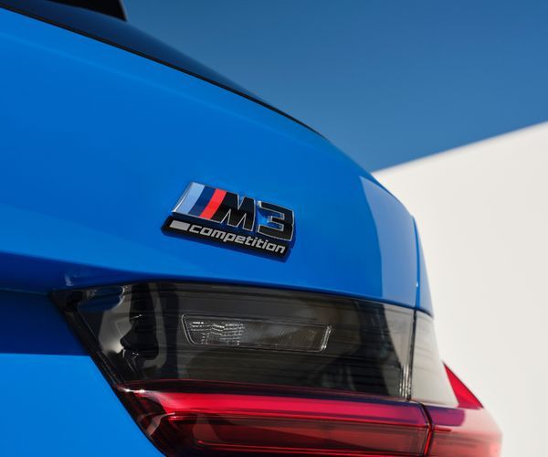 Close up of the rear end of a blue BMW M3.