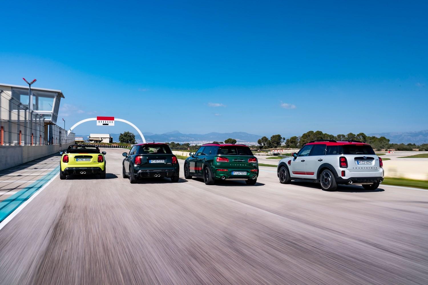The new MINI John Cooper Works range in different colours, driving towards finish line on racetrack