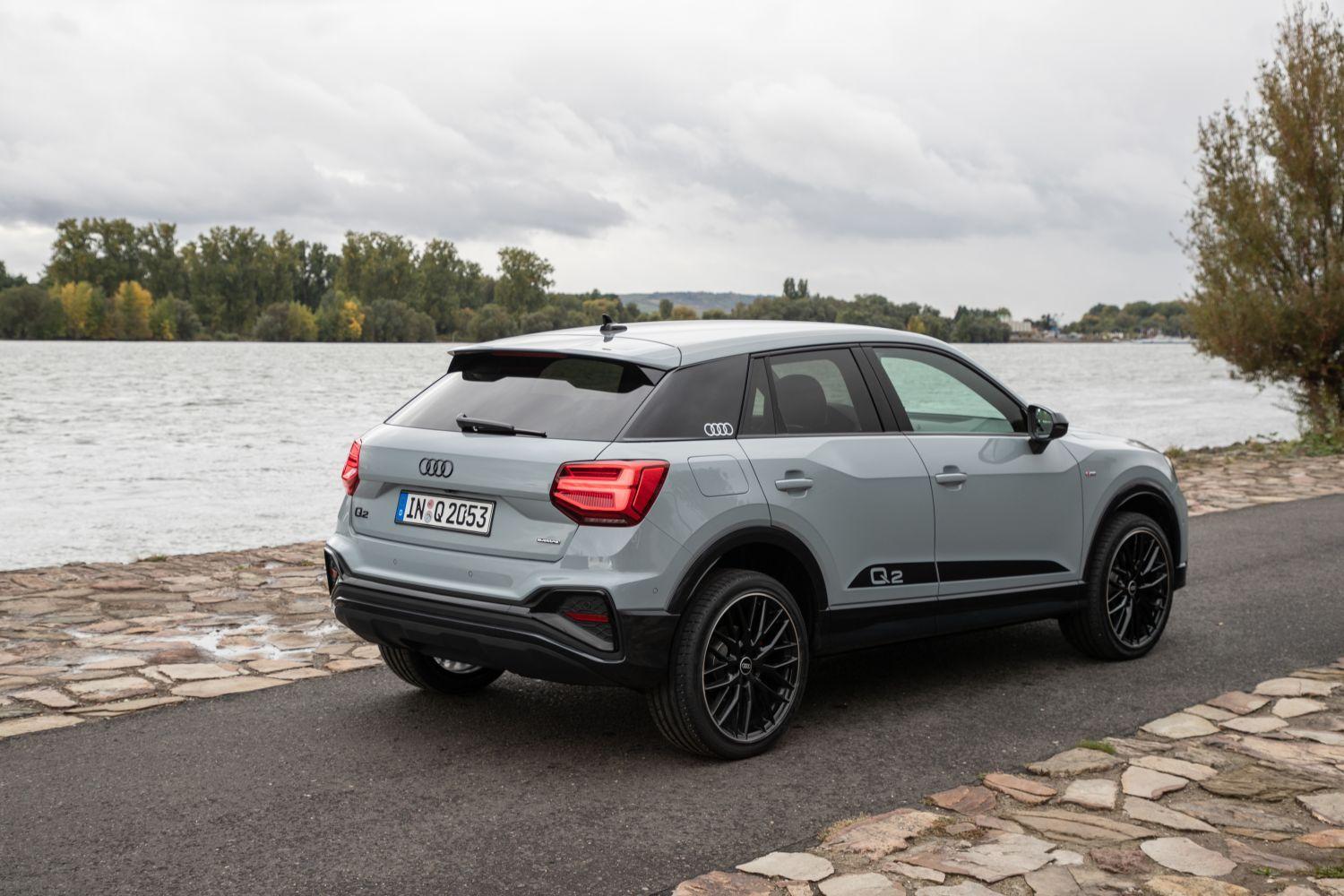 New Audi Q2 vehicle side view showcasing sporty black alloys and Q2 side strip