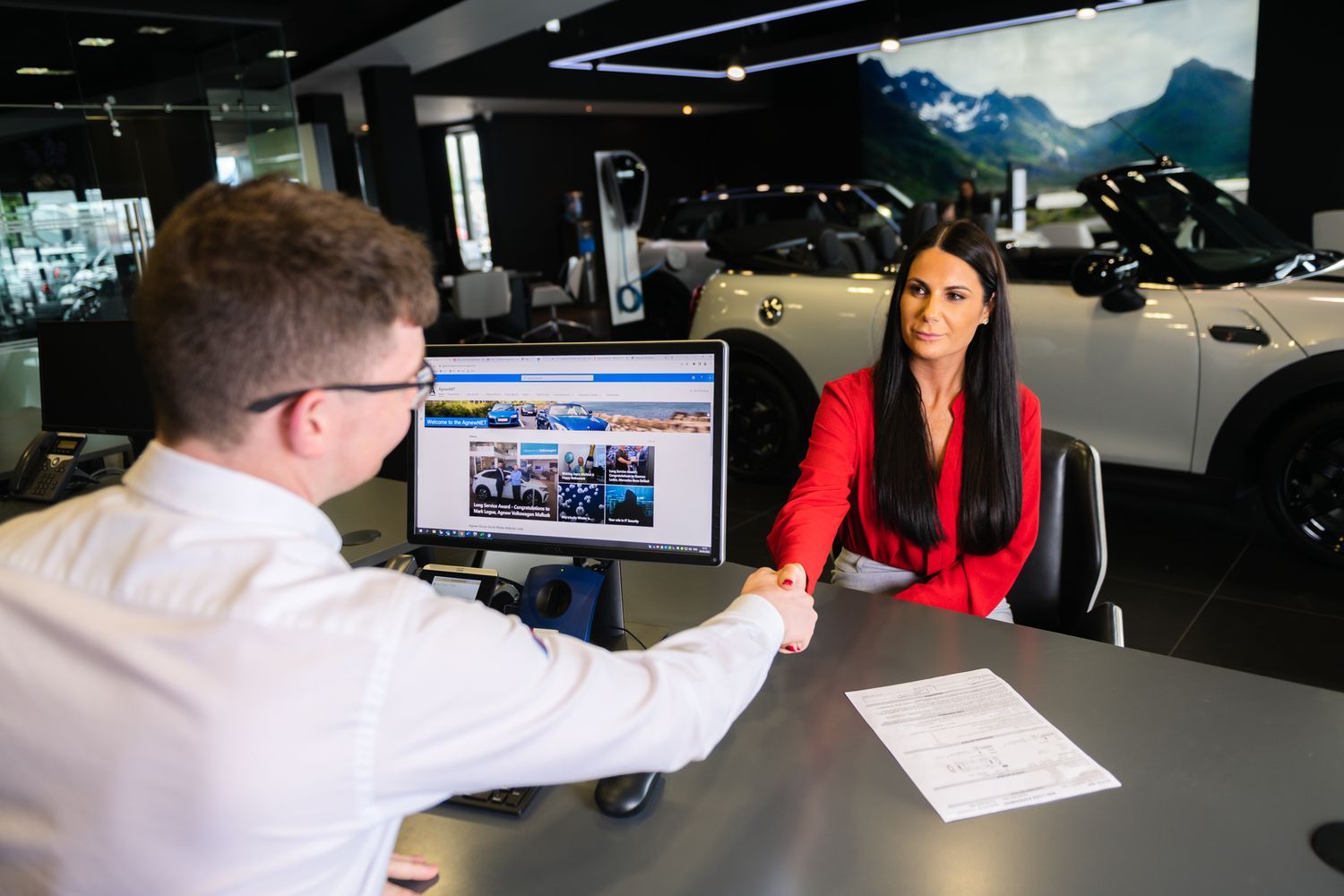 MINI Finance Advisor shakes customers hand at Bavarian MINI after agreeing which finance package was best for them.