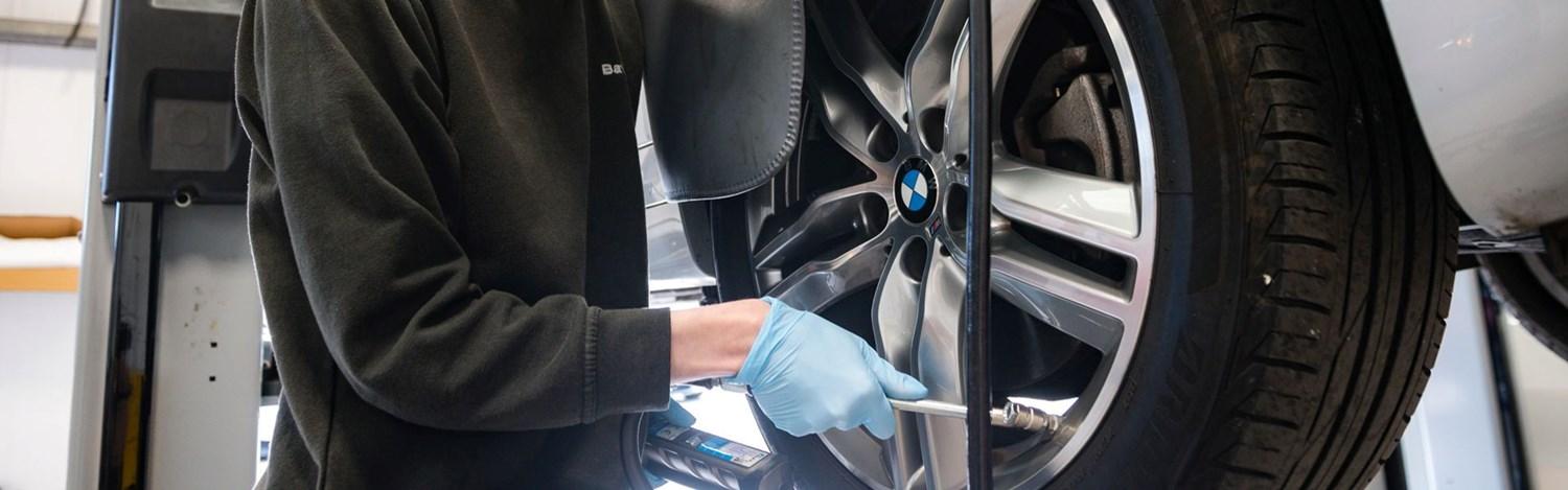 BMW Technician tests the tyre pressure of BMW vehicle during wheel repair at Bavarian BMW Belfast