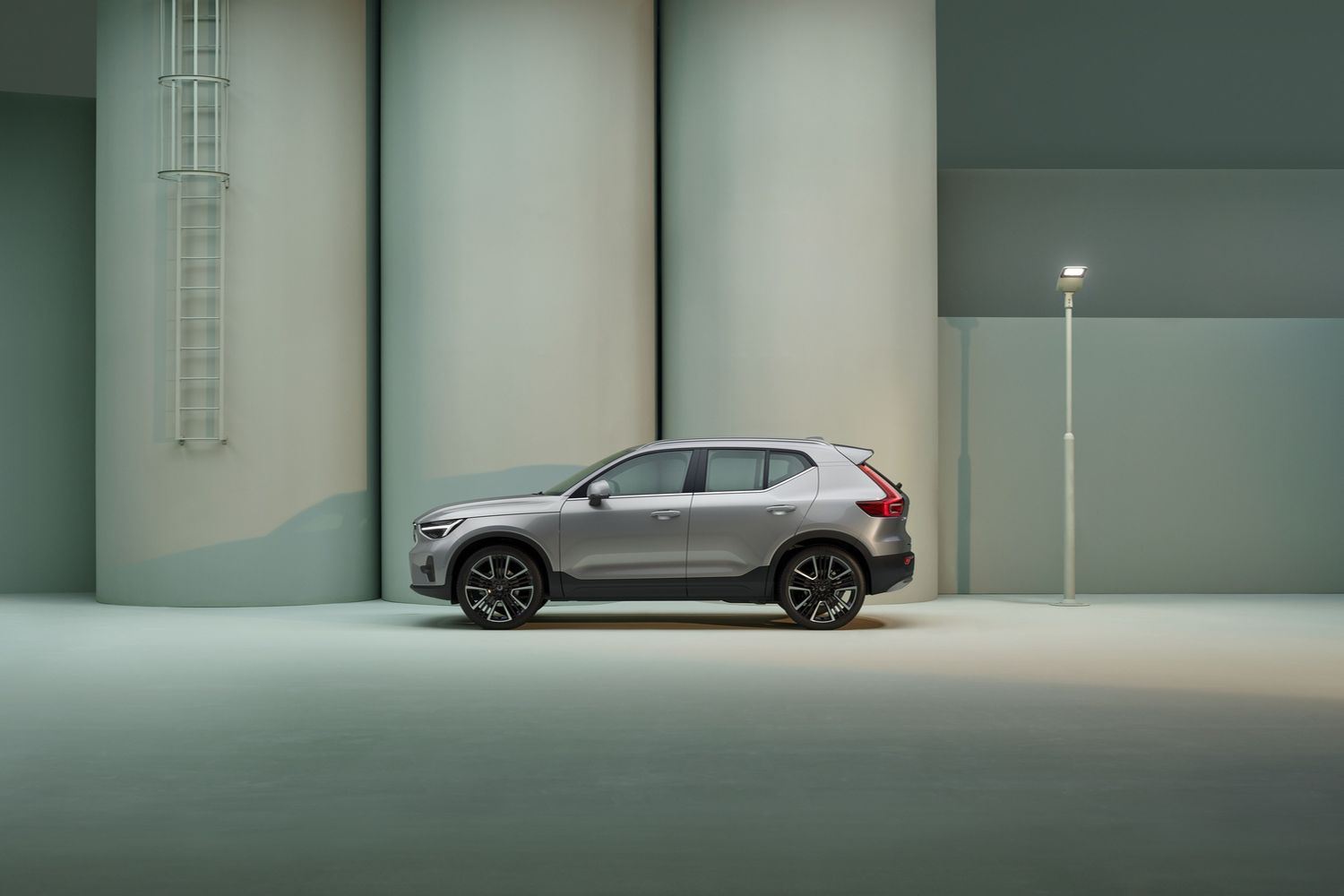 Side view of the new Volvo XC40 in silver, parked on industrial street