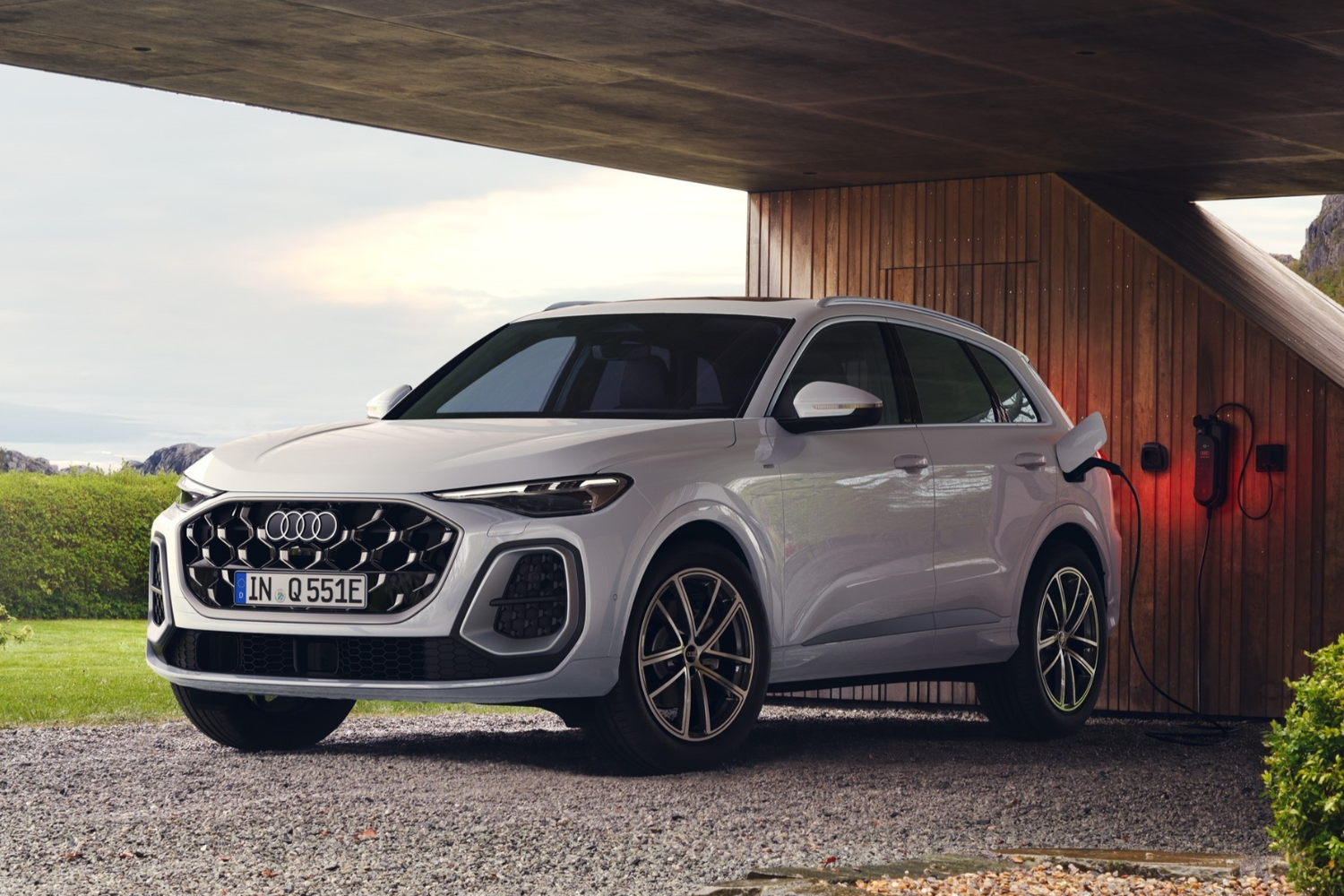 The new Audi Q5 e-hybrid charging at a charging port.