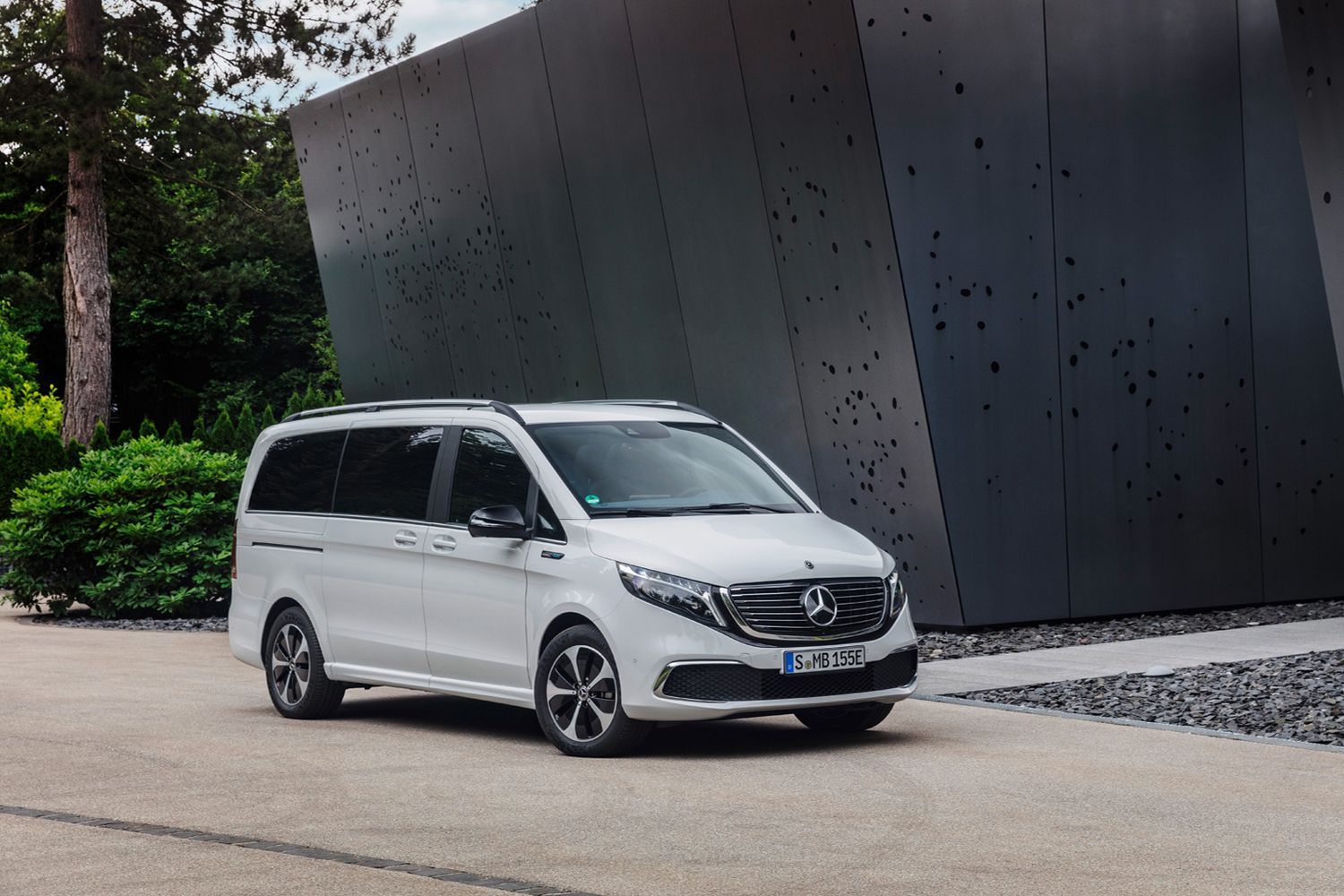 Side view of a parked white Mercedes-Benz EQV.