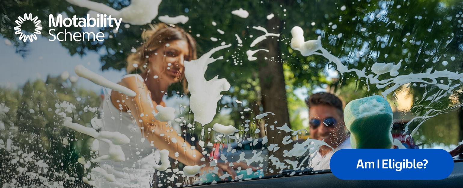 Am I eligible for Motability Banner showing a man and a woman washing a car