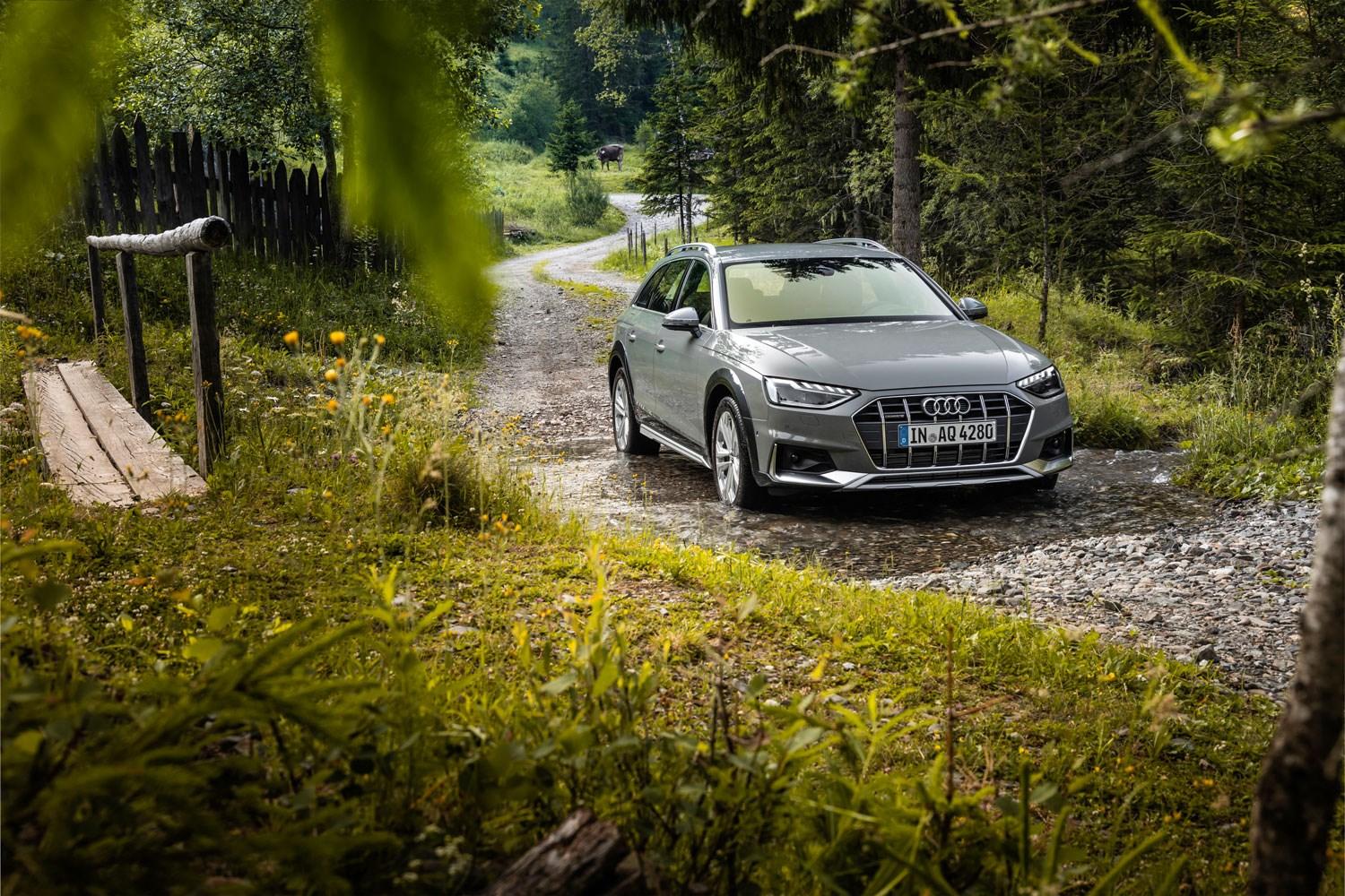 Audi Q3 TFSI e drives along rocky road with wildflowers at either side