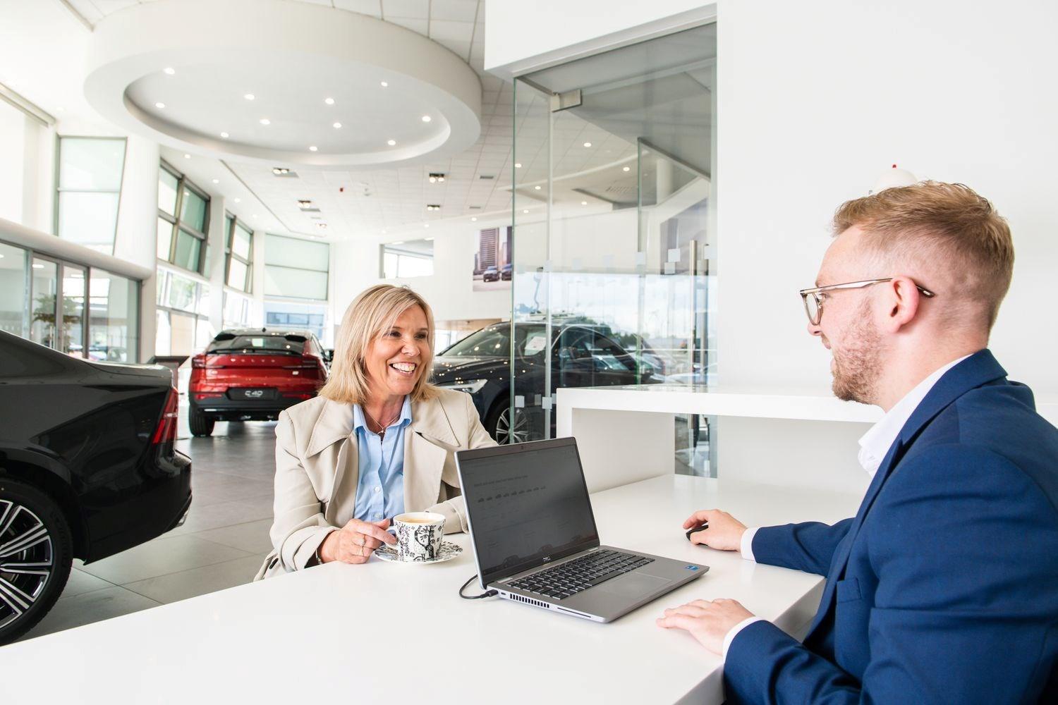 Customer smiles as they discuss Motability options at the Agnew Volvo Belfast showroom