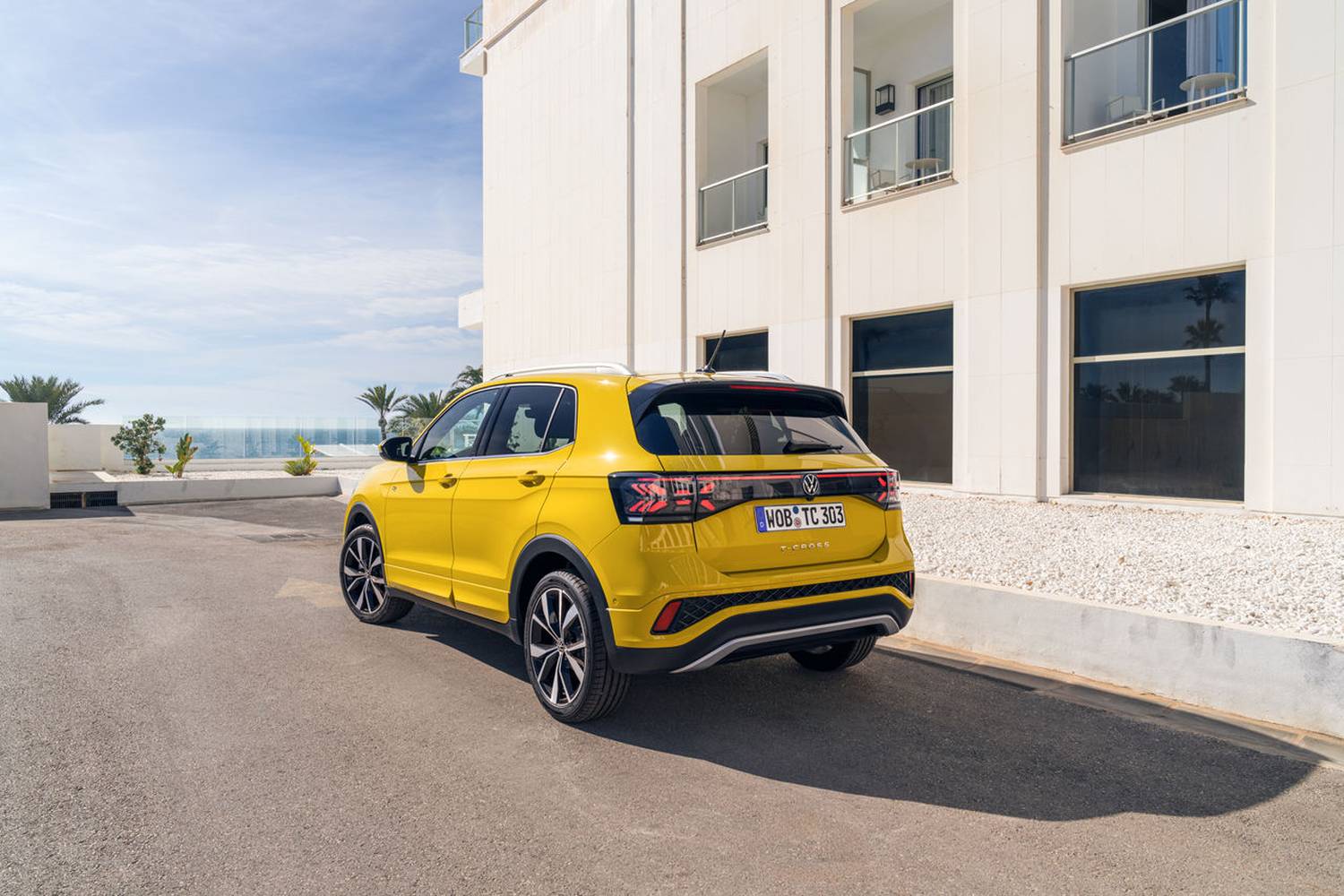 Rear view of the Volkswagen T-Cross R-Line parked beside a white building