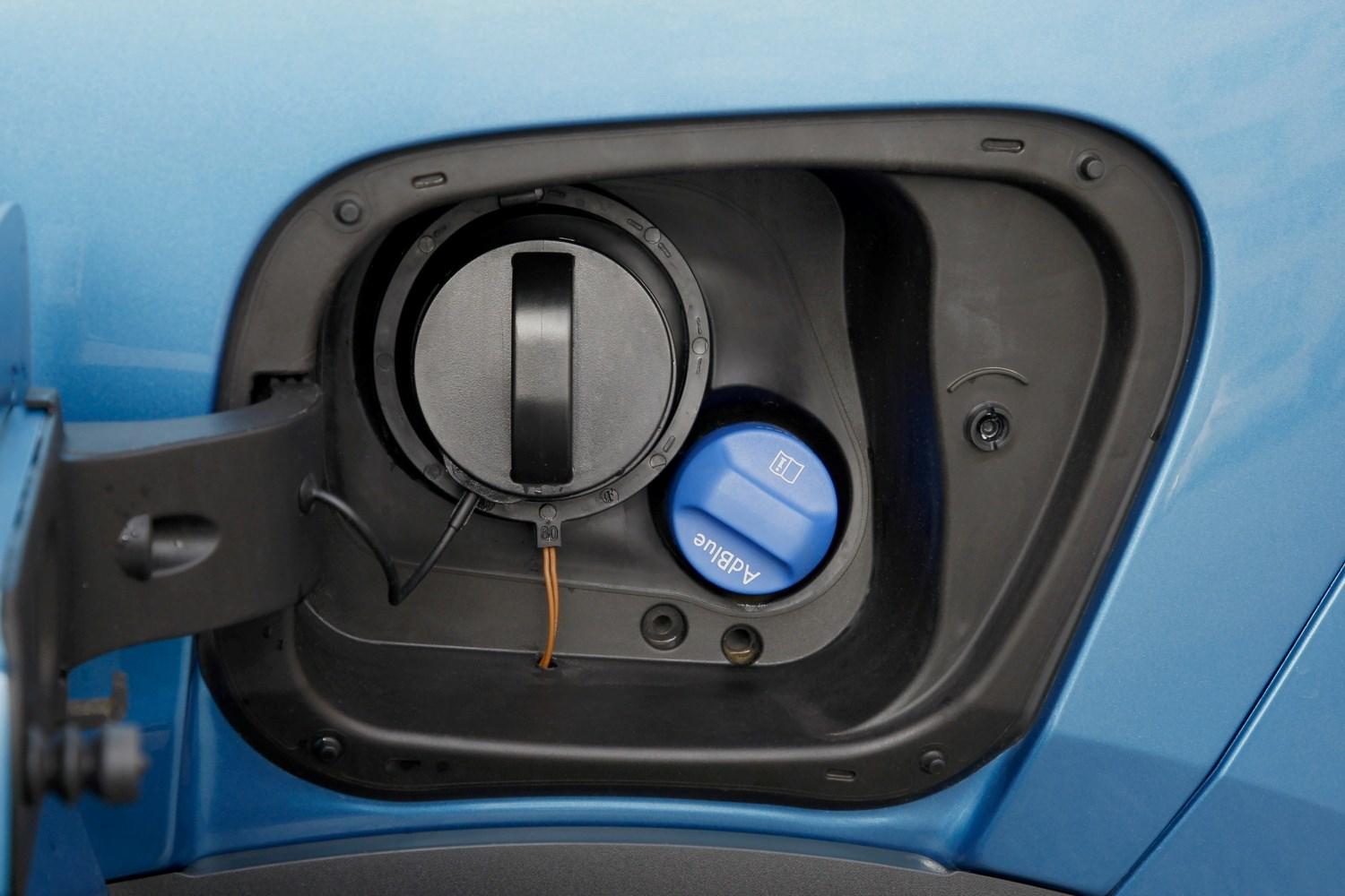 Close-up of a new blue Volkswagen Polo diesel and AdBlue fuel caps.