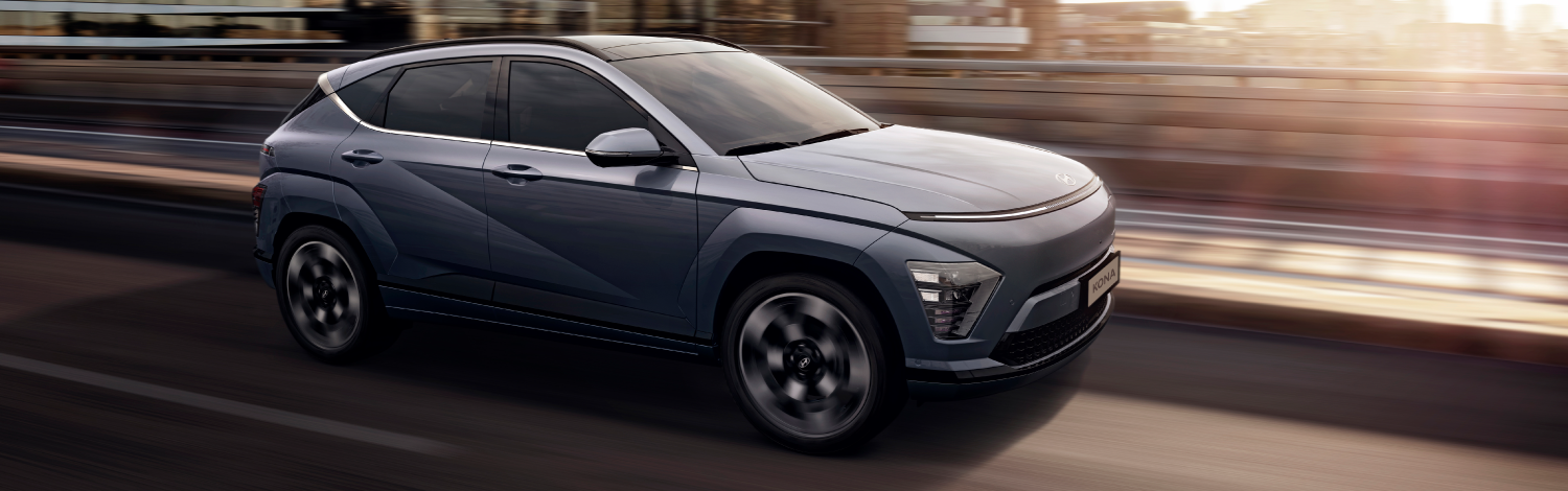 Dark Coloured Hyundai KONA EV in motion on a city road