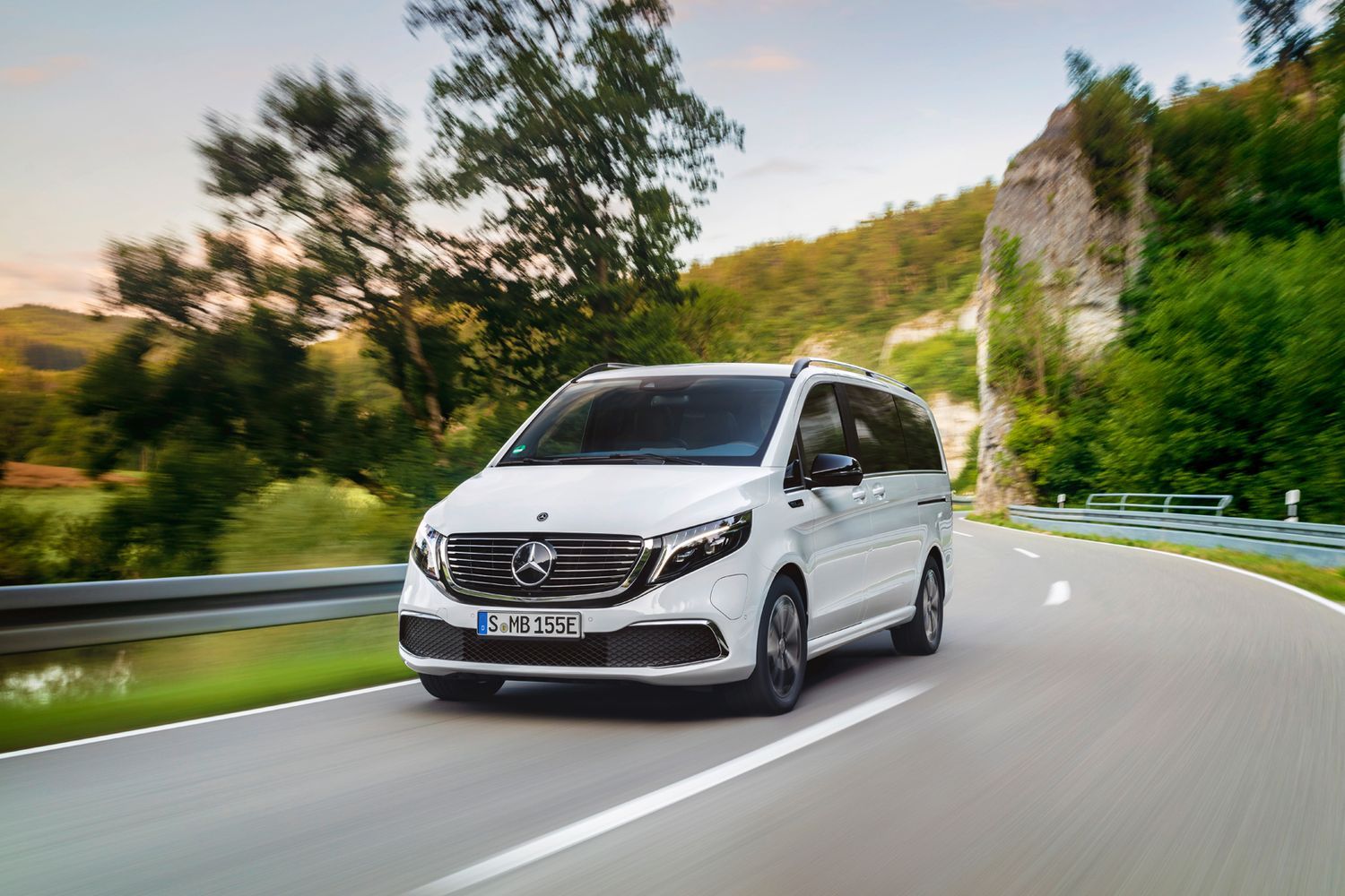 Front view of a white Mercedes-Benz EQV driving.