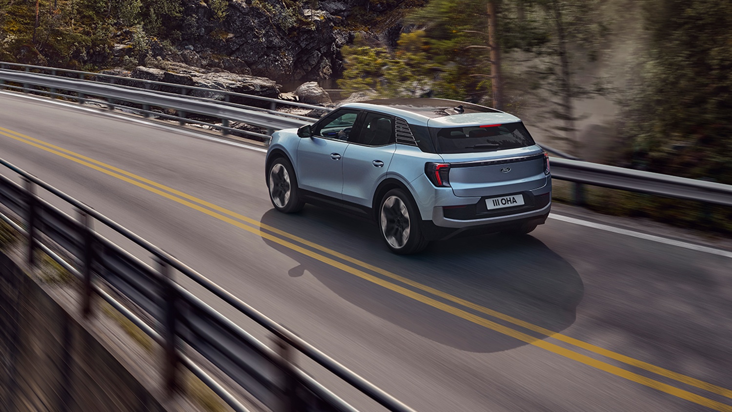 Silver Ford Kuga driving down road