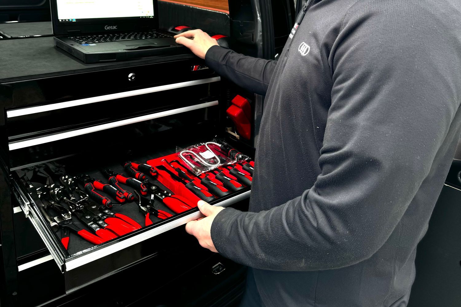 Close-up of mobile technician van laptop and tools, located in the rear of the van