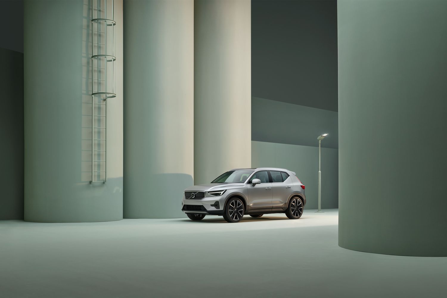 Front and side view of the new Volvo XC40 in silver, parked on industrial street