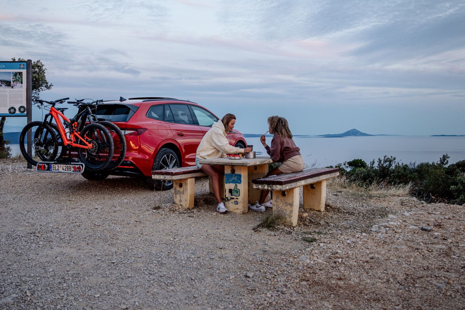 Skoda Accessory Packs, available at Agnew Skoda Belfast and Mallusk. Couple eat on picnic bench with Cycling Pack installed