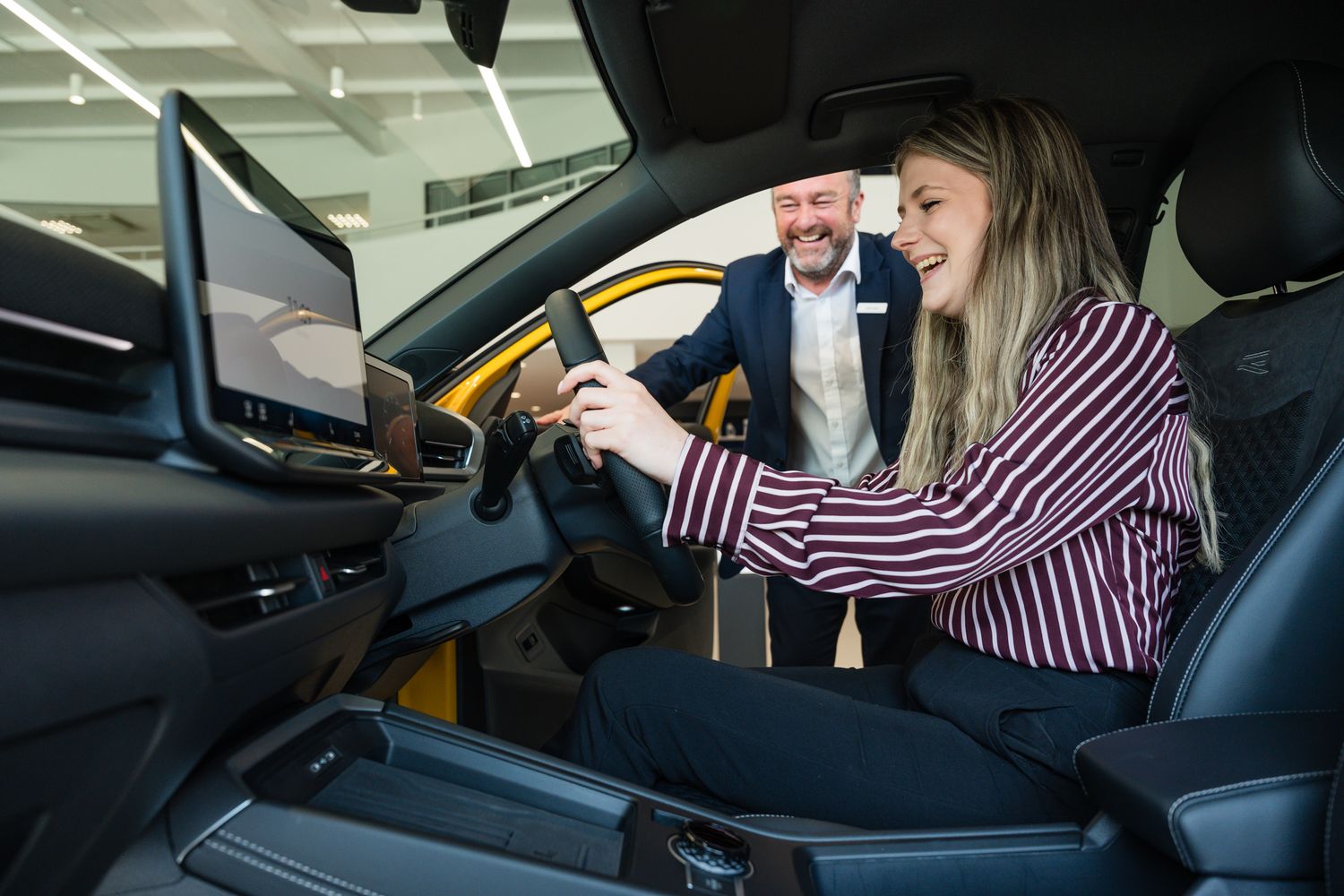 Agnew Volkswagen Belfast customer chats to Sales Manager inside the latest Volkswagen T-Roc