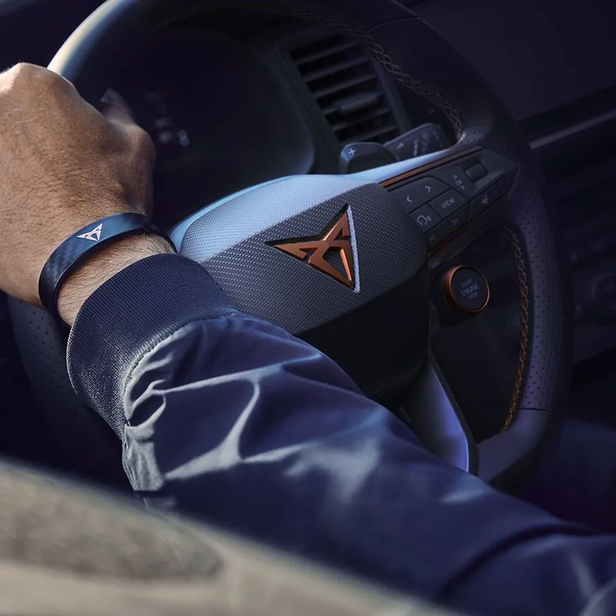 Hand on CUPRA steering wheel