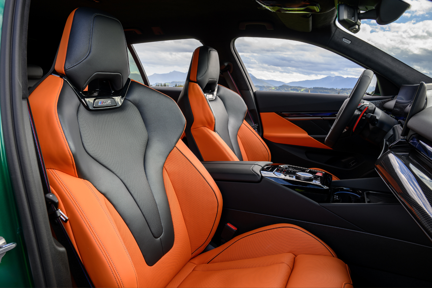 BMW M5 Touring black and orange leather seats and interior.
