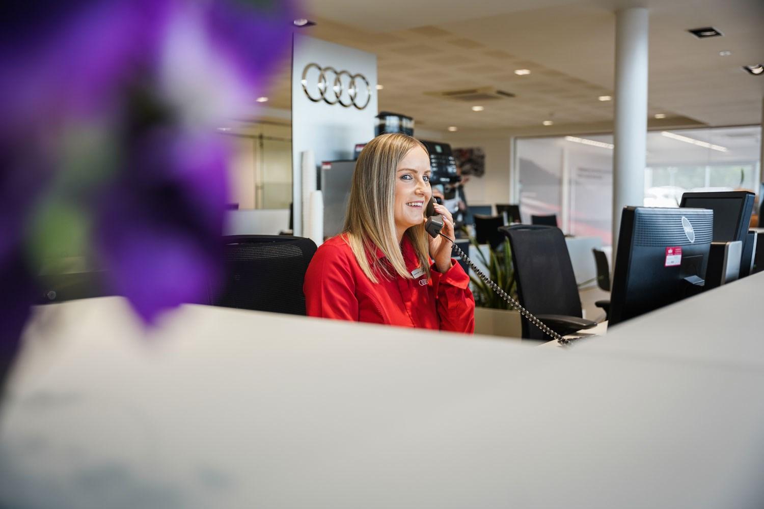 Audi Customer Service Specialist helps customer book in for a repair by phone at Belfast Audi