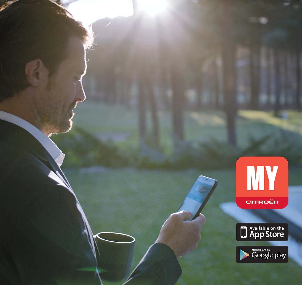 A man using the Citroen Mycar app on his smartphone