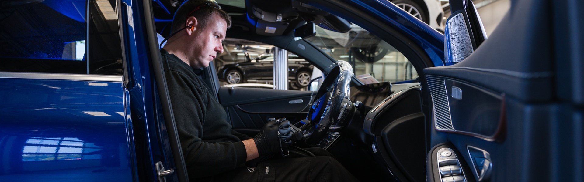 Mercedes-Benz Technician inspects the inside of a Mercedes-Benz vehicle during routine maintenance work at the Mercedes-Benz Repair Centre
