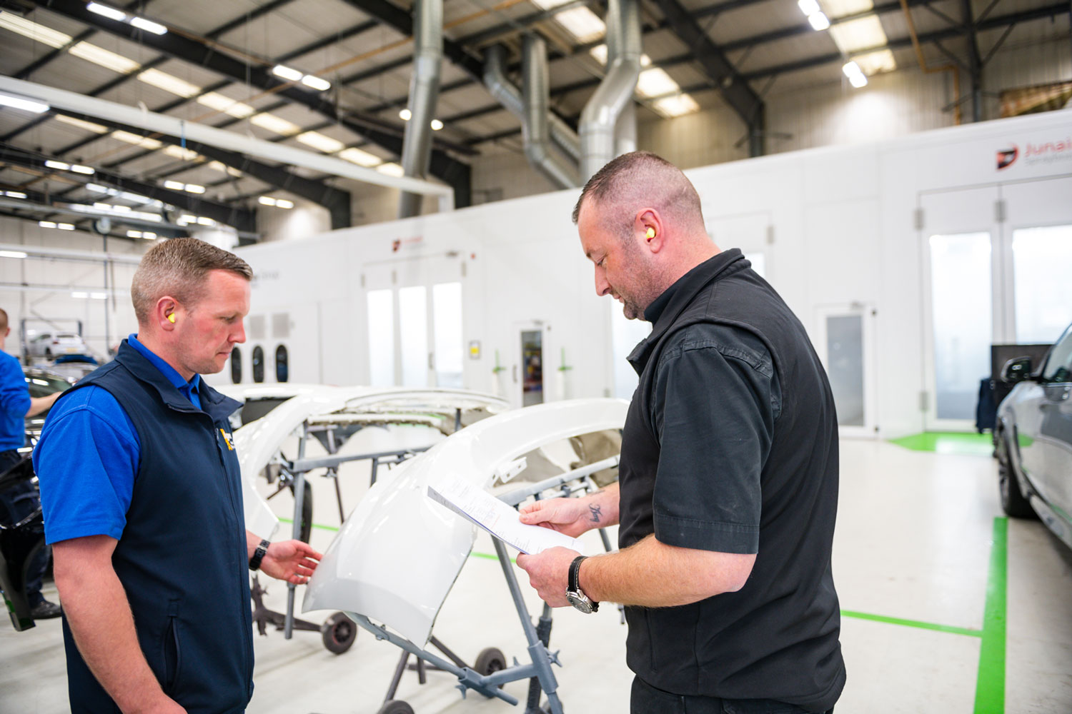 Agnew Repair Centre Specialist Technicians discuss repair work needed for vehicle