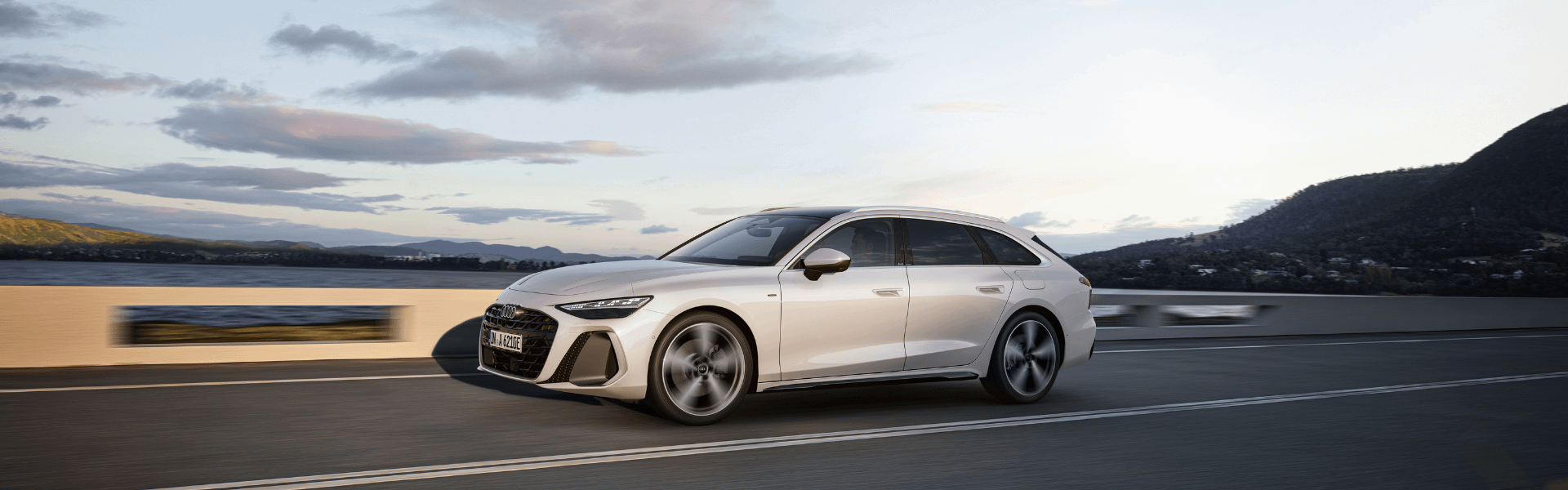 Audi A6 Avant e-hybrid 2025 driving side view of vehicle