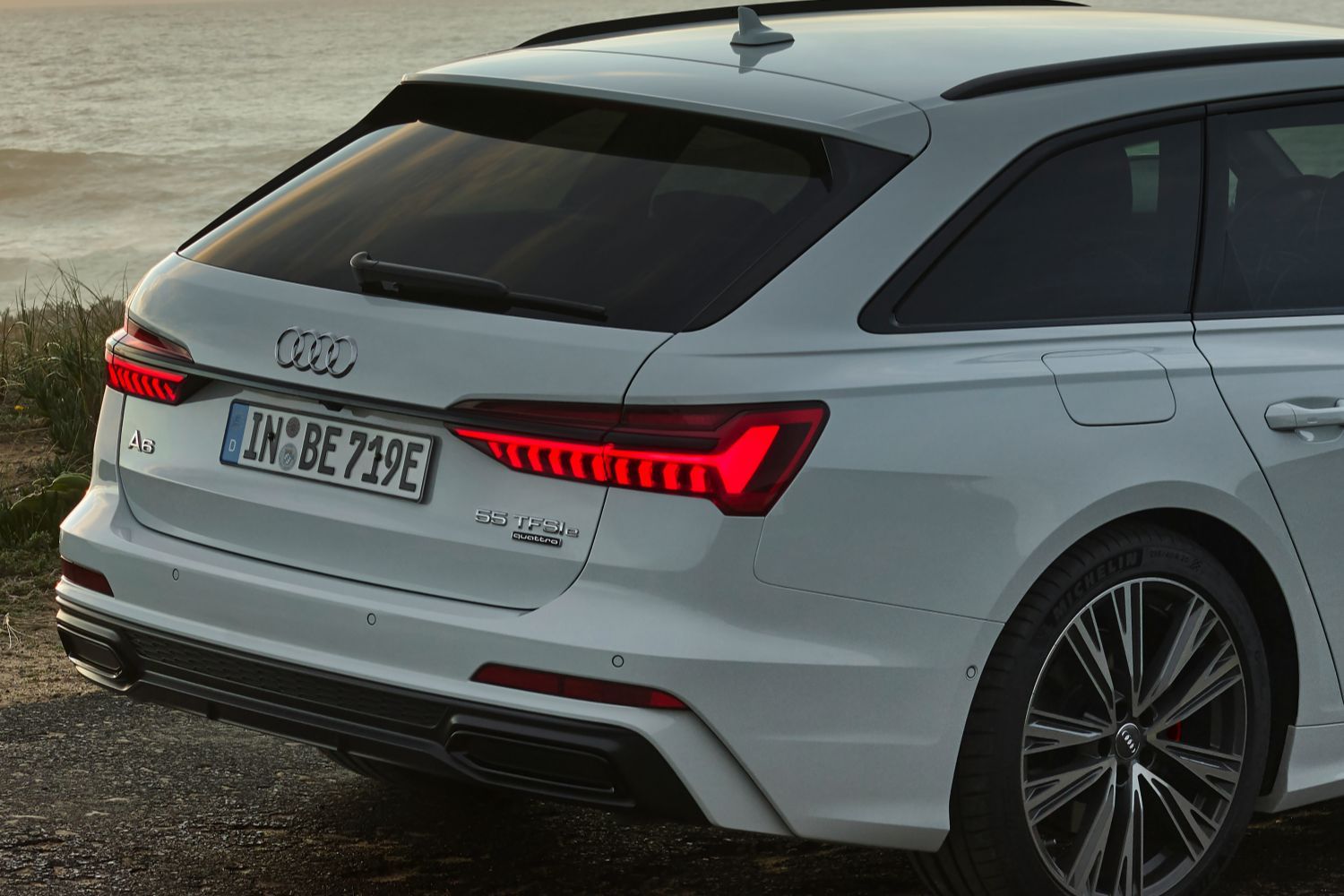 New Audi A6 Avant TFSI e in white view of the back of the vehicle showcasing the sporty brake lights