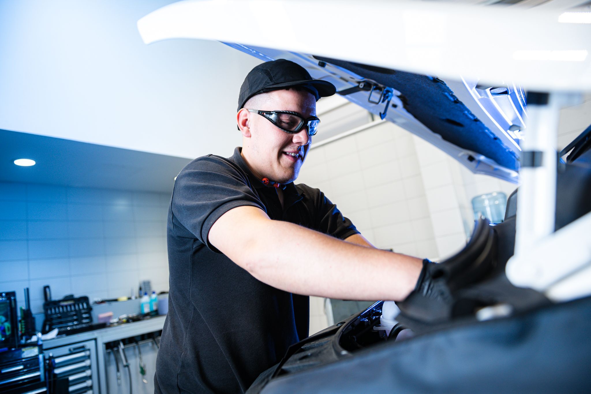 Volkswagen Commercial Vehicle Technician inspects under the hood of van during healthcheck
