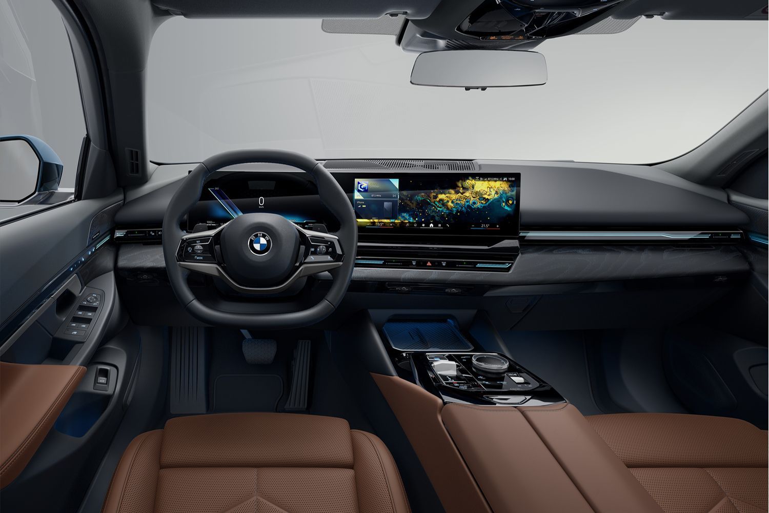 Interior view of the new BMW 5-Series Touring, close-up front passenger seats, steering wheel and infotainment system