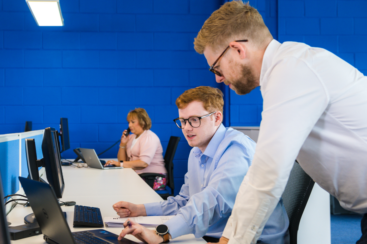 Two members of Agnew Leasing Staff working together in the office.