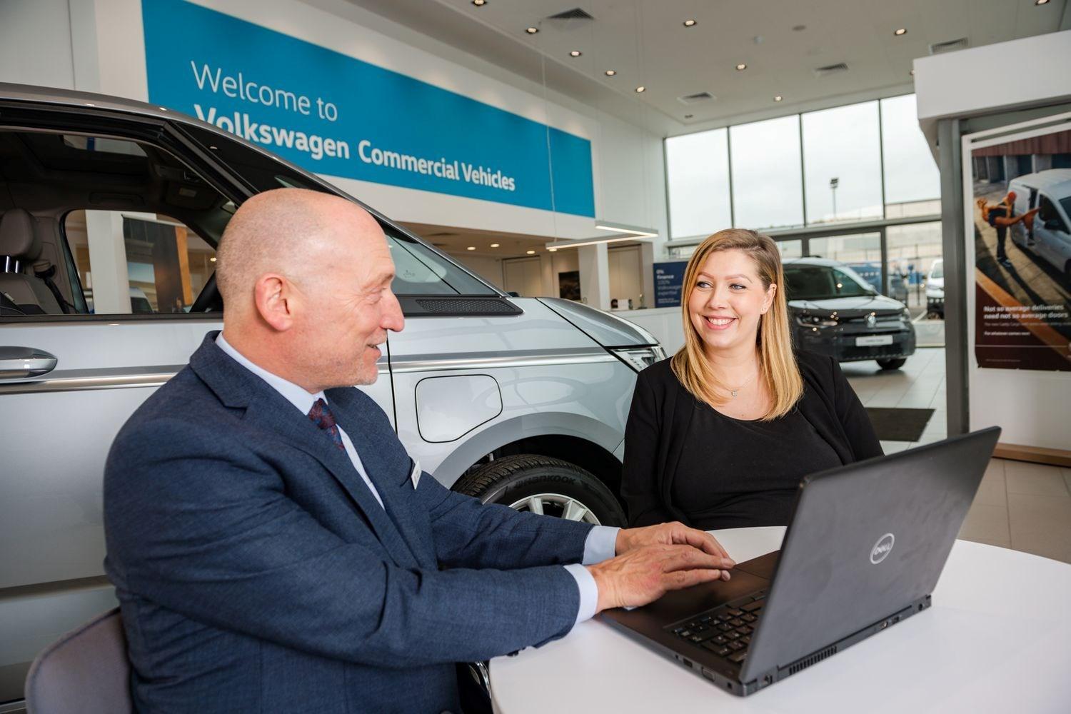 Volkswagen Commercials Finance Specialist talks to customer about the different finance packages available in the Agnew Van Centre showroom, Mallusk.
