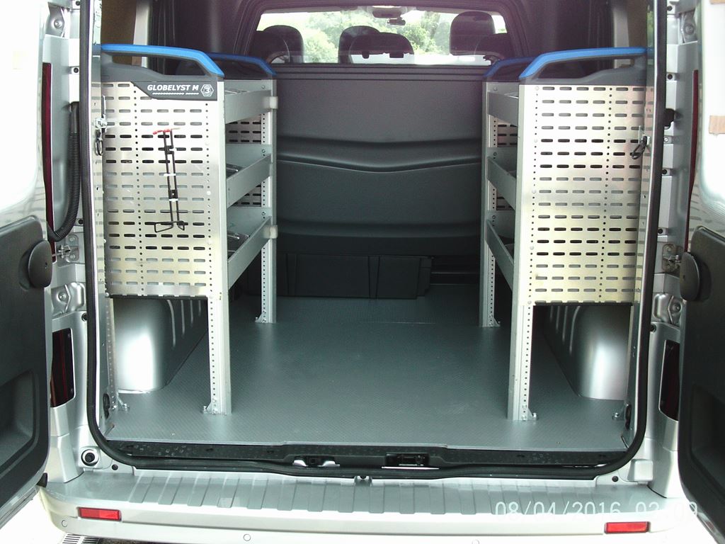 Rear view of van interior with twin racking units and open central loading space.