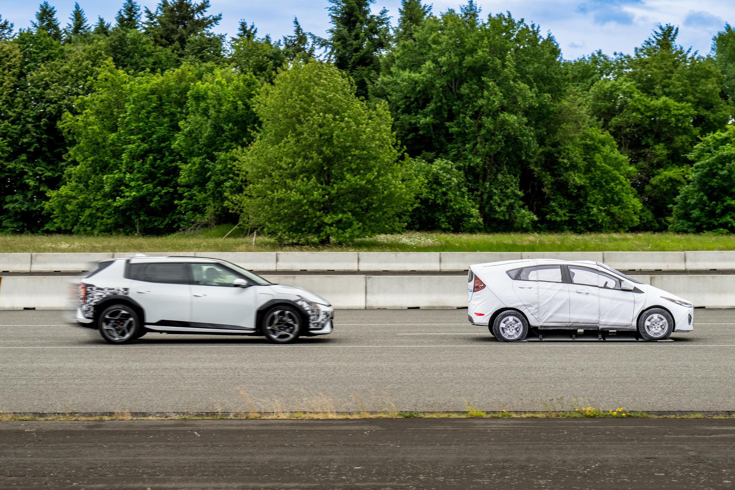 Two white Kia Cars