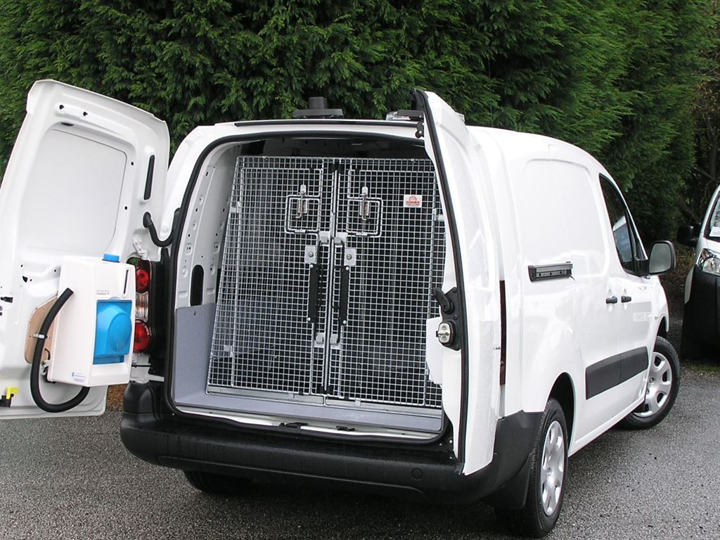 White service van with rear doors open, showing a secure mesh cage inside the load area.